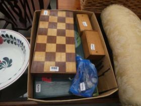 Box containing chess pieces, a board and board games