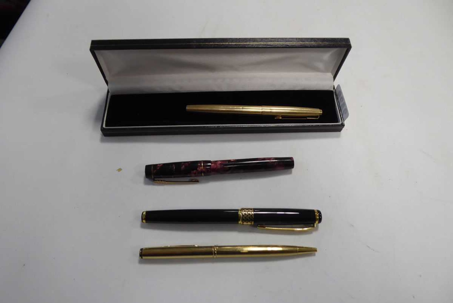 Two Parker pens and two other pens