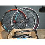 4 bike wheels and a box containing handle bars, brackets, etc