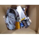 Cardboard box containing paintbrushes, spirit levels and small tools