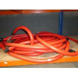 Reel of red rubber hose/pipe