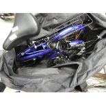 Blue fold up bike with bag