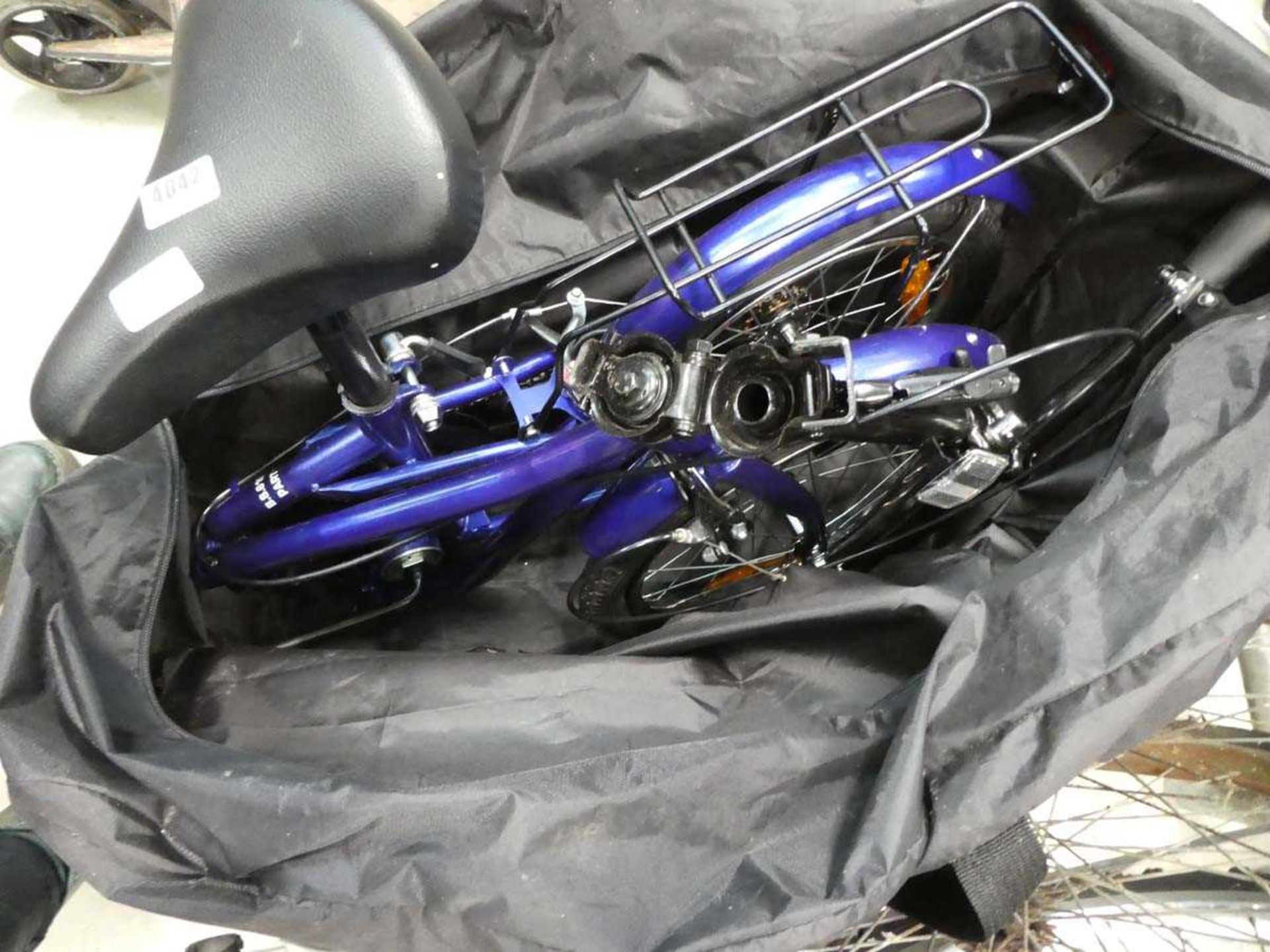 Blue fold up bike with bag