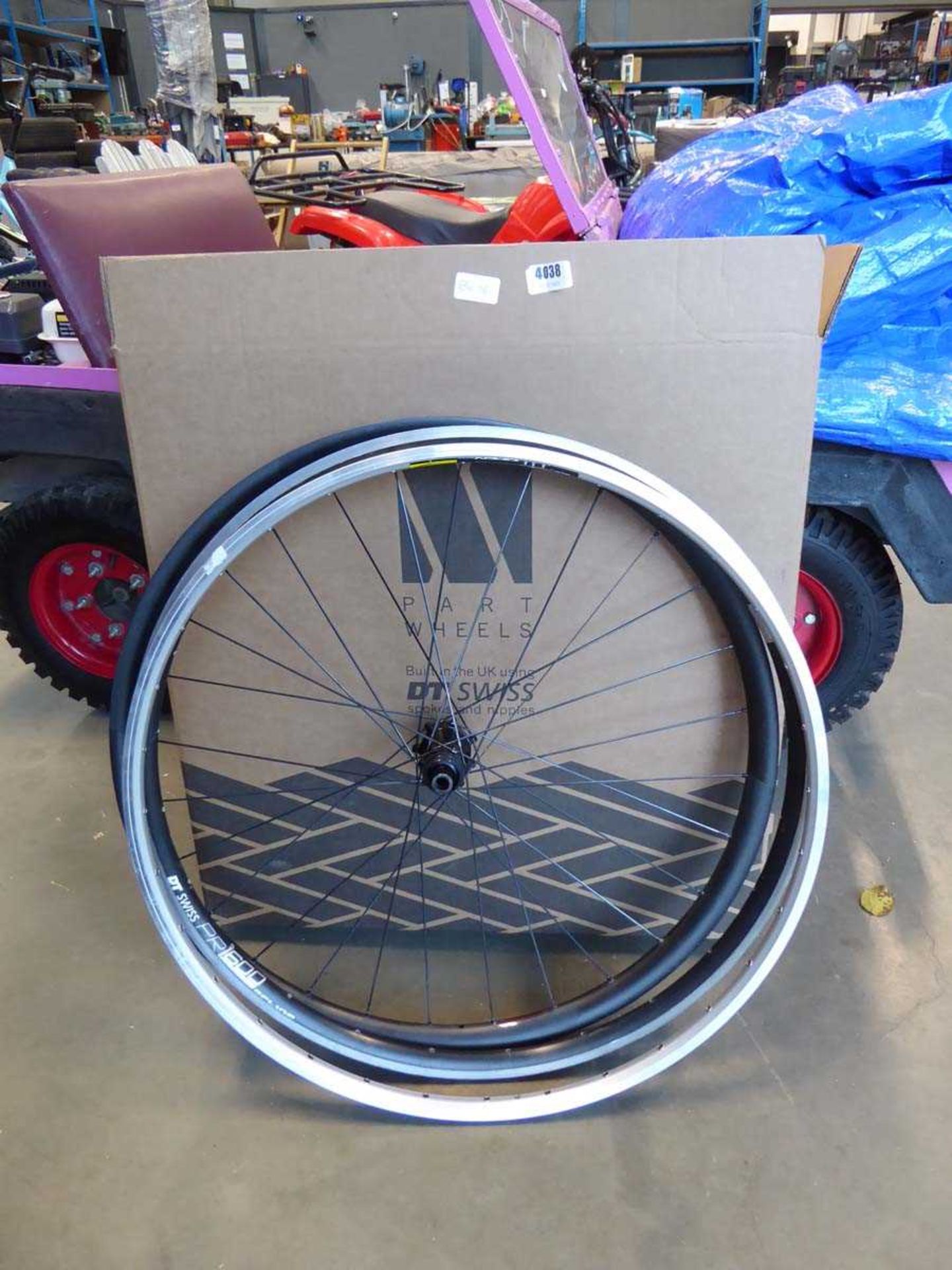 A bike wheel and 2 bike rims