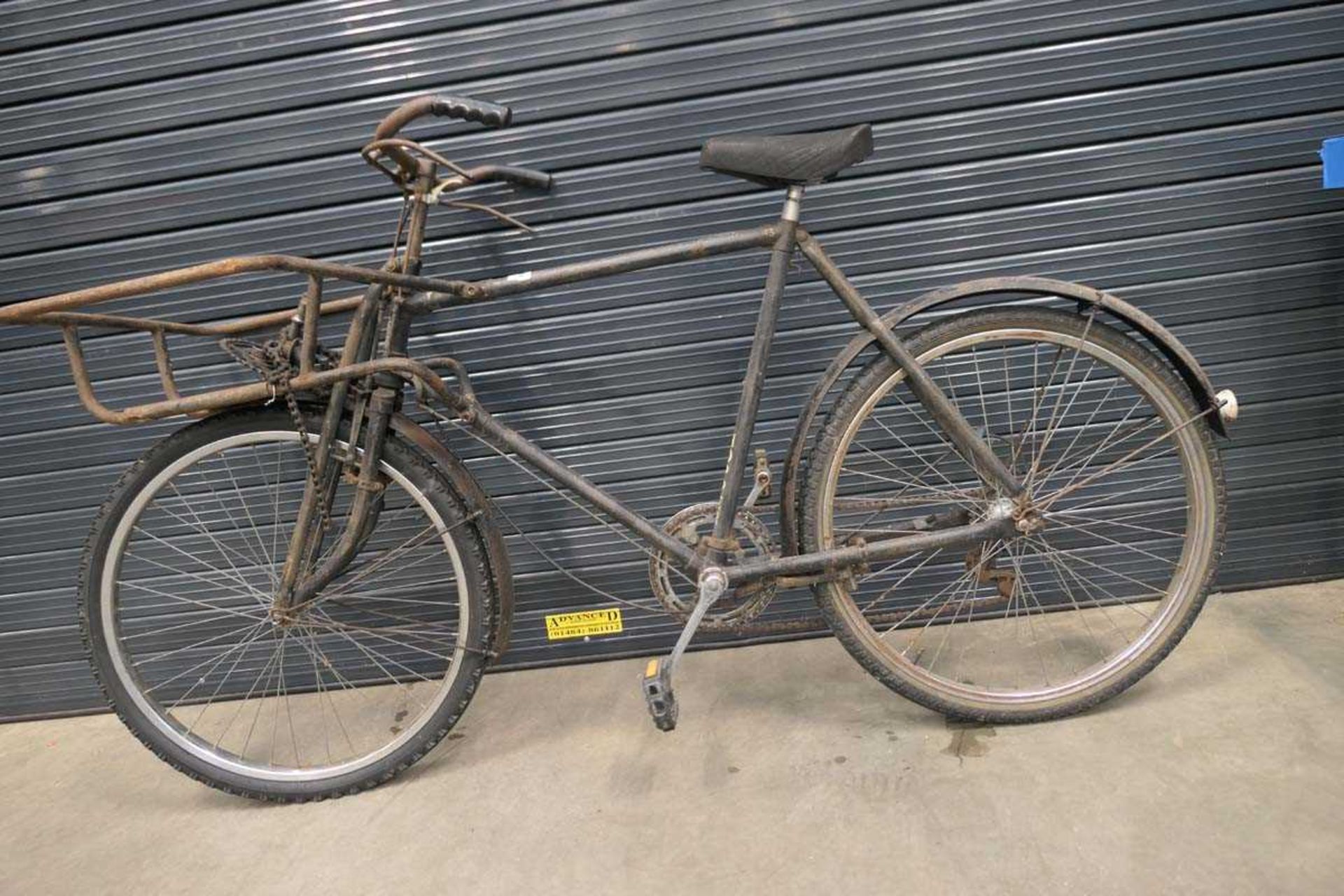 Vintage black bike with front basket and spare wheels