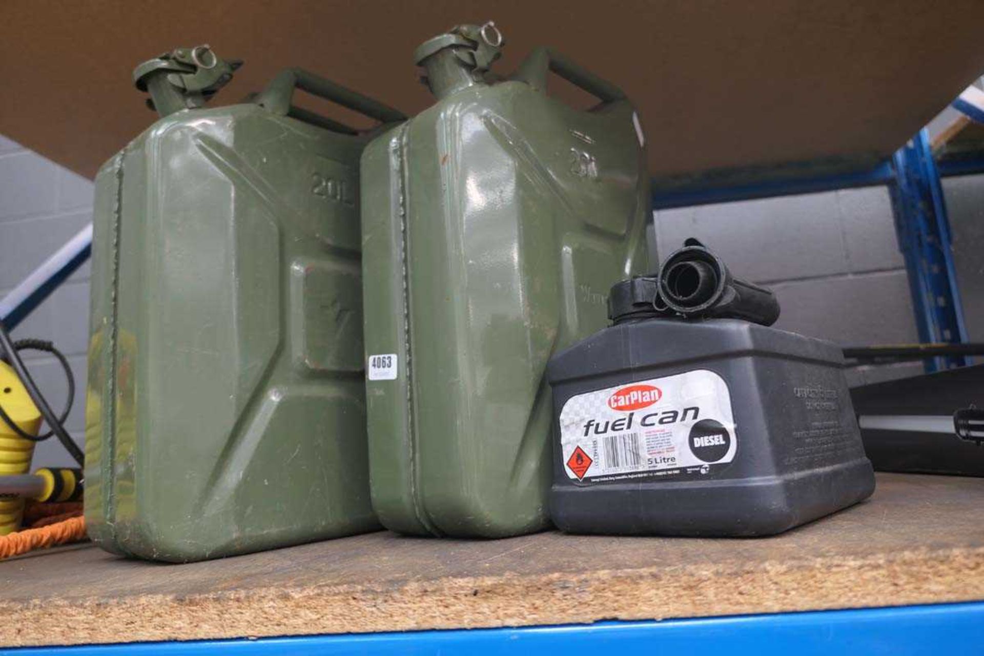 2 metal jerry cans and a fuel can