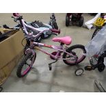 Small child's pink bike with stabilisers