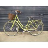 Green ladies bike with front and back basket