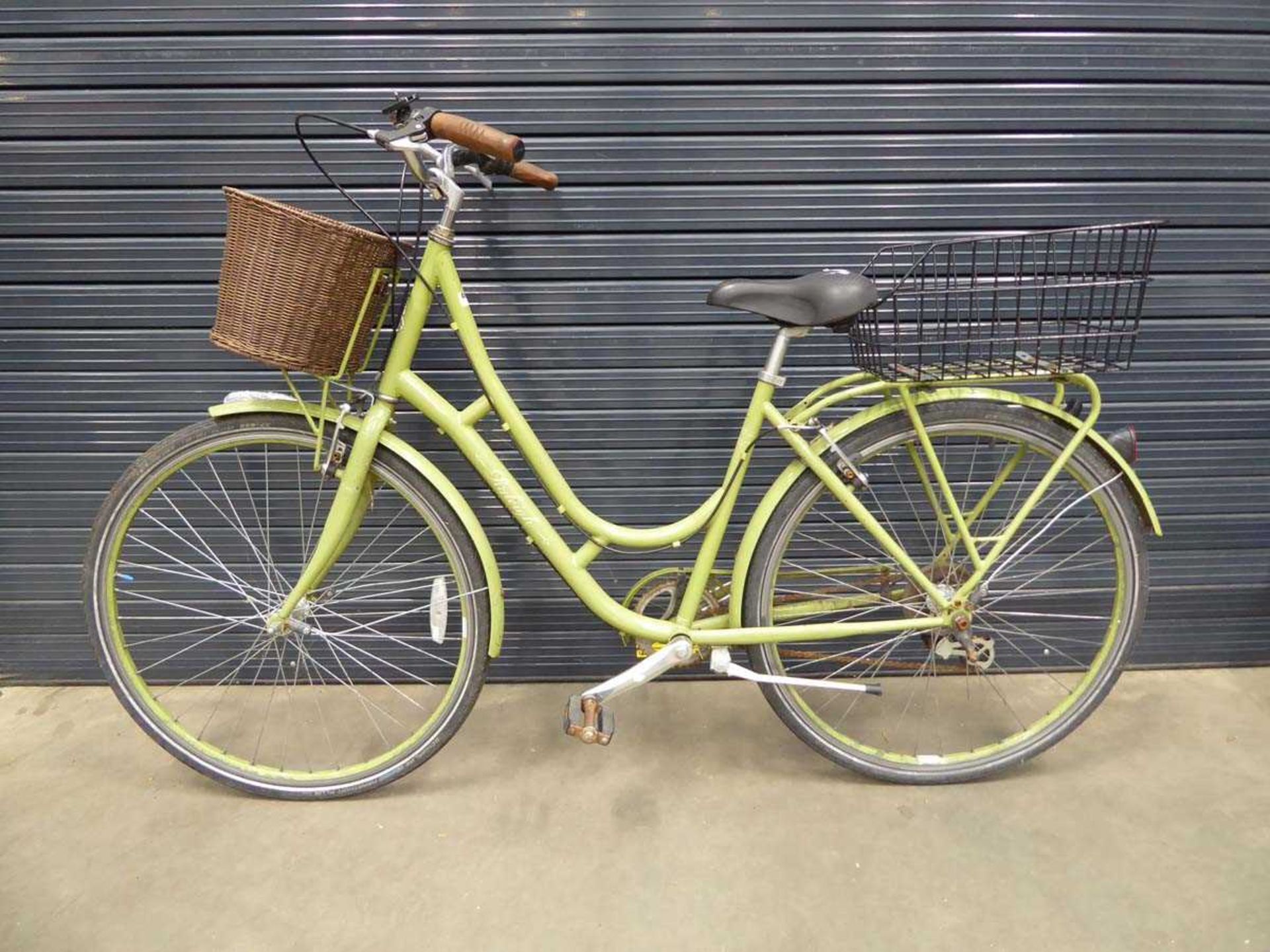 Green ladies bike with front and back basket