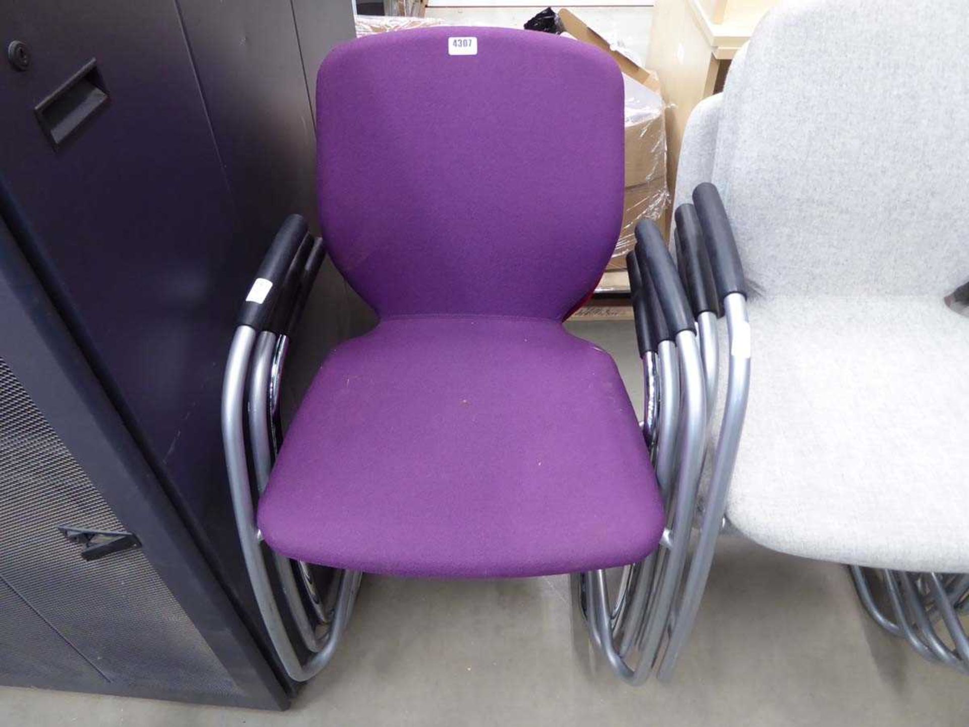 Three assorted coloured stacking chairs