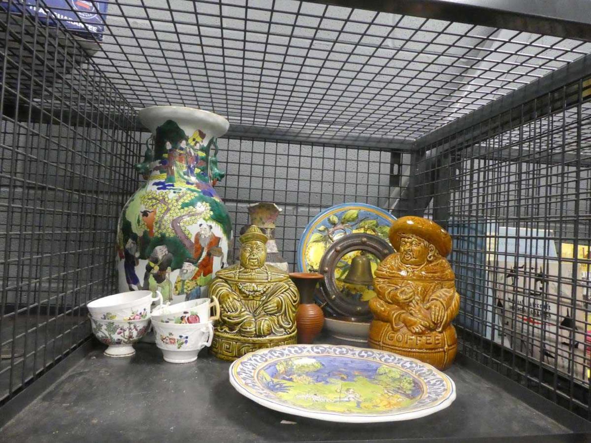 Cage containing modern coffee and teapots, oriental vase, cups and collector plates