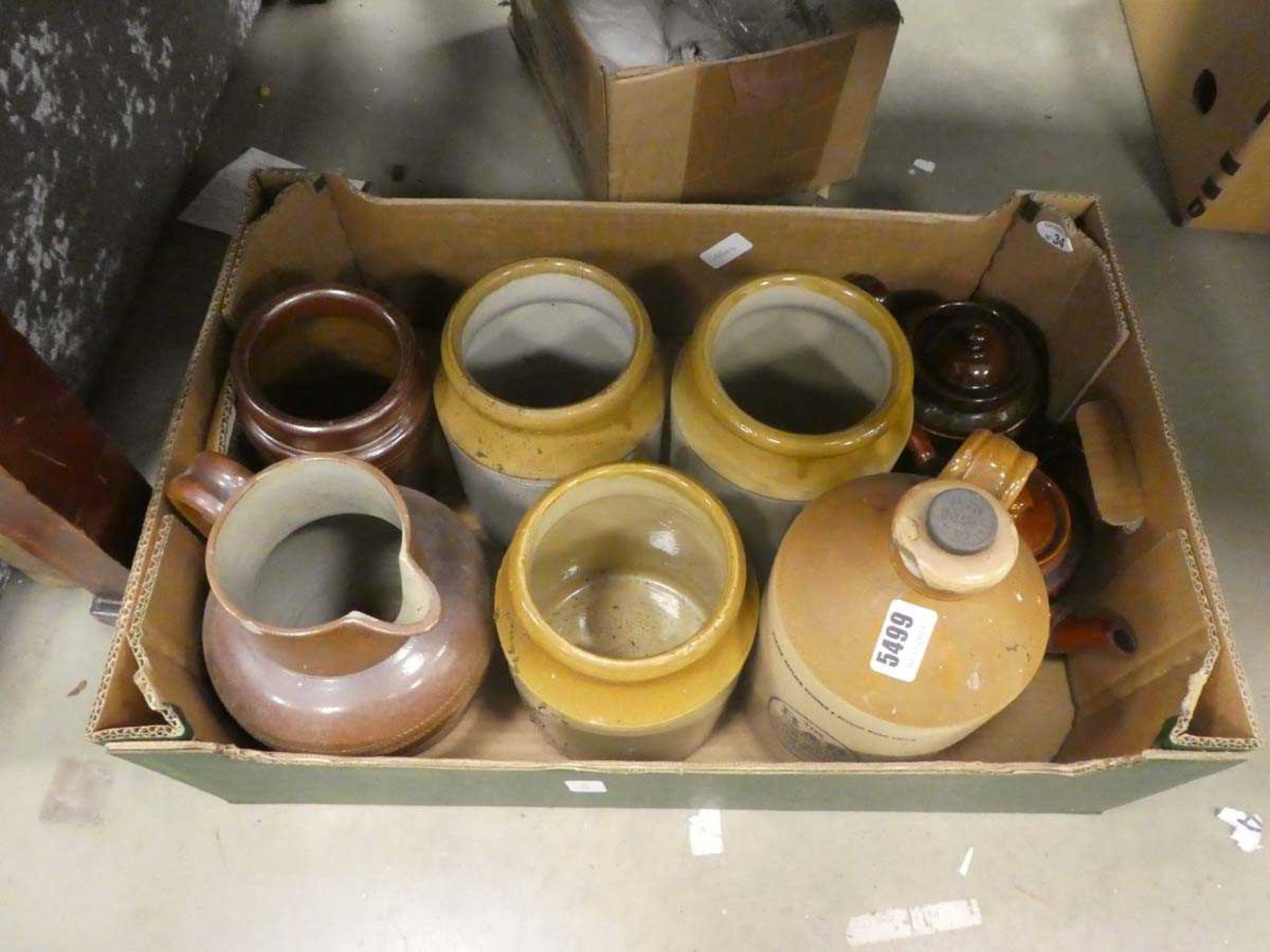 Box containing teapots, cider jar and kitchen storage vessels