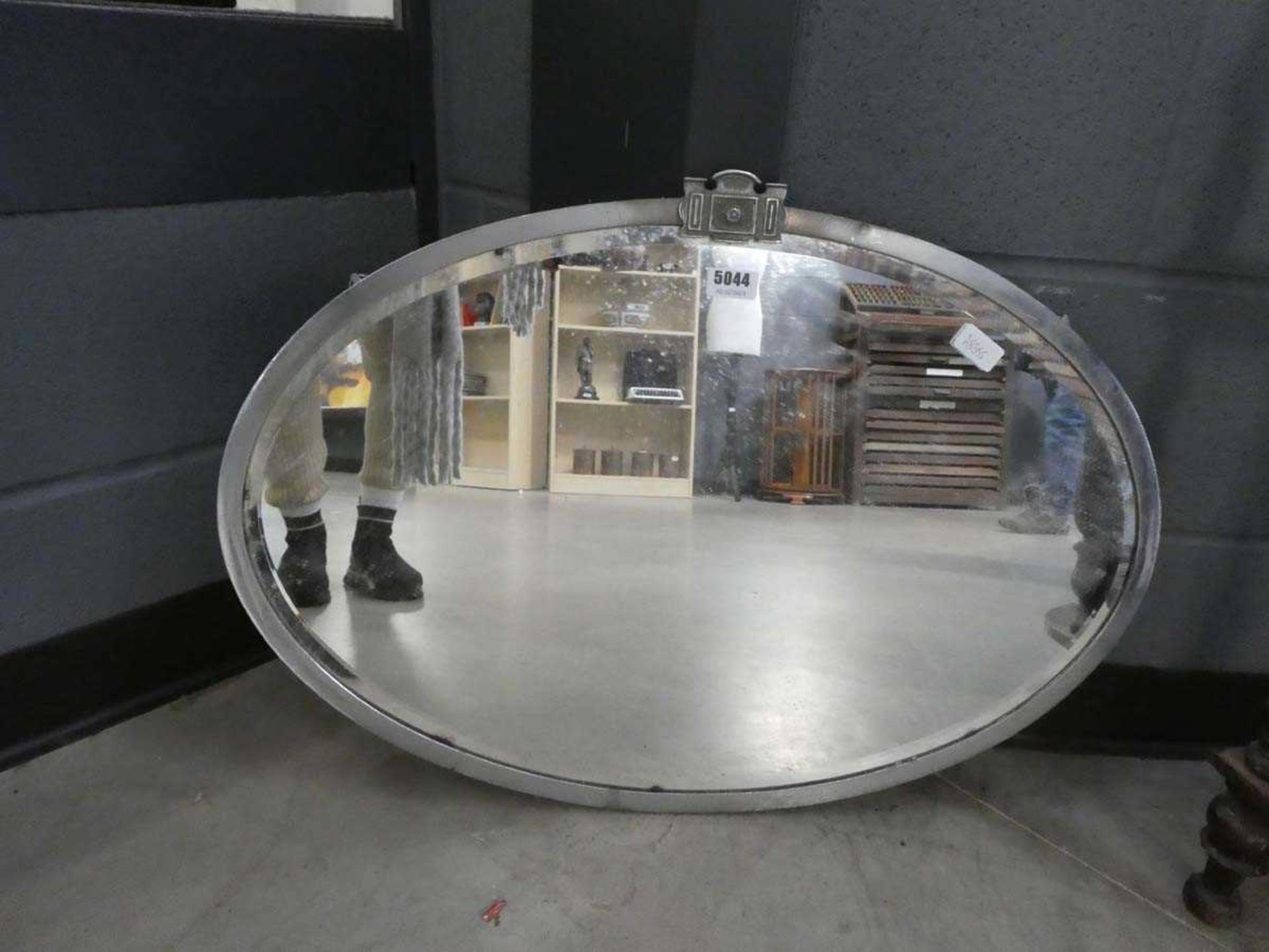Oval bevelled mirror in chromed frame