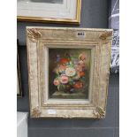 Still life with flowers in ornate frame