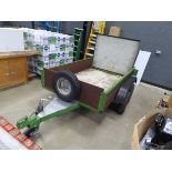 Double axle green metal and wood plant trailer with fold down backboard