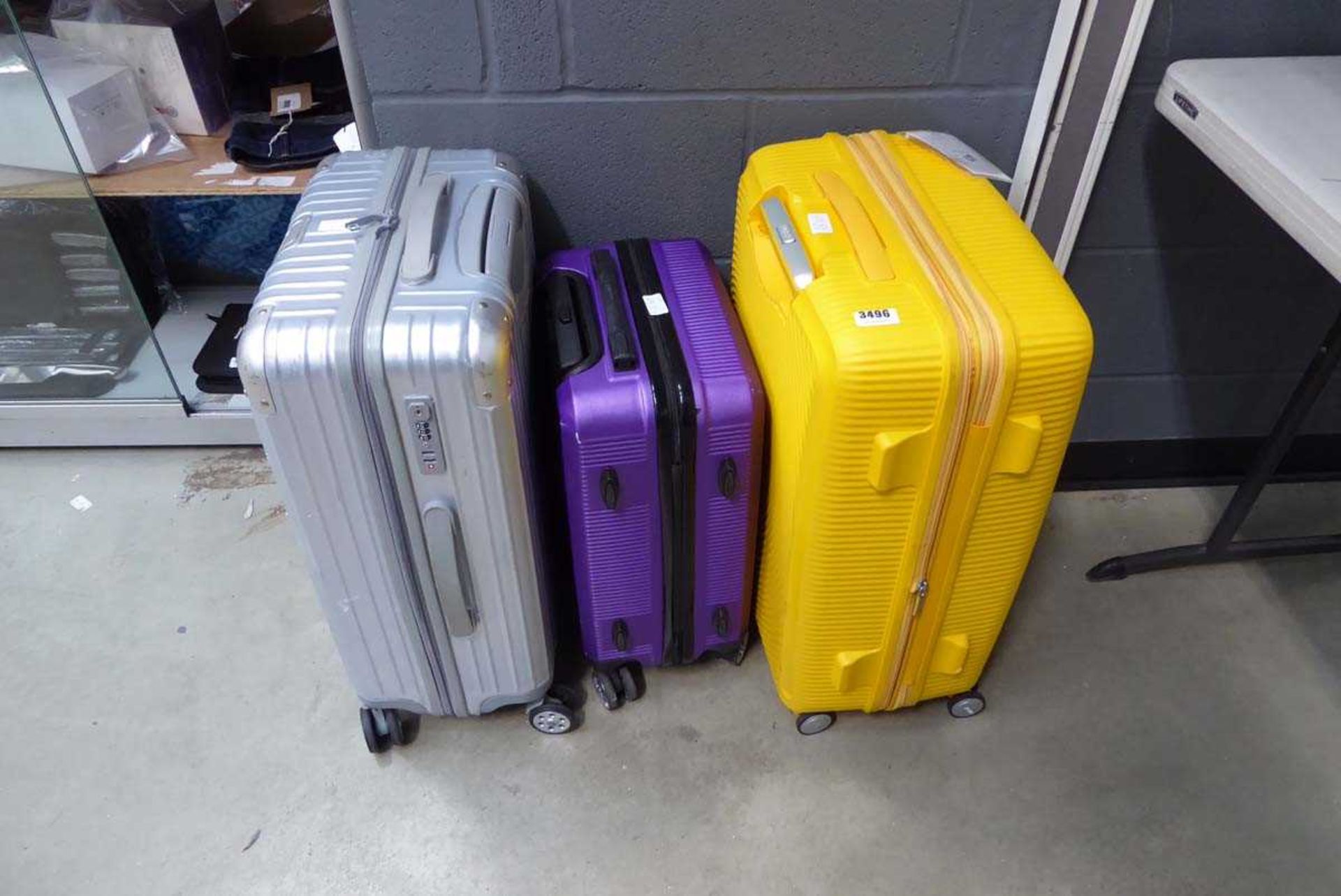 Three mini hard shelled suitcases