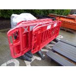 Ten red plastic road work barriers