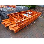 Three running bays of large orange pallet racking