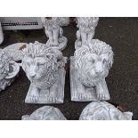 Two small laying concrete lions