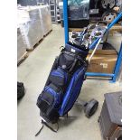 Blue and black golf trolley with quantity of Maxfli clubs