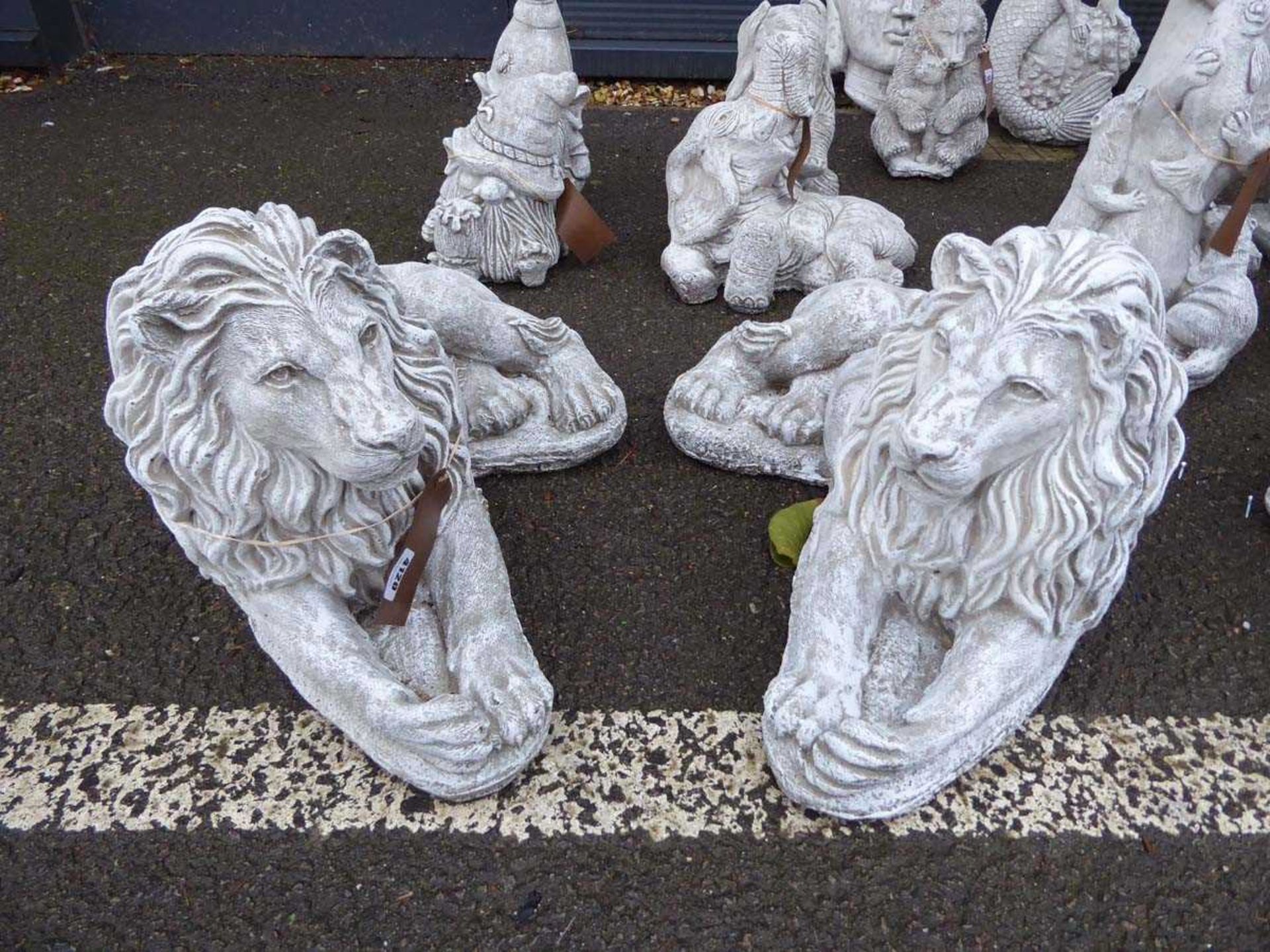 Two large laying concrete lions
