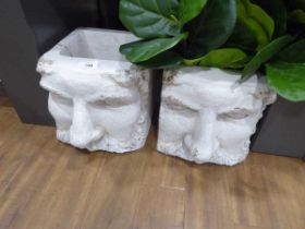 +VAT Pair of moulded face design planters with artificial plants