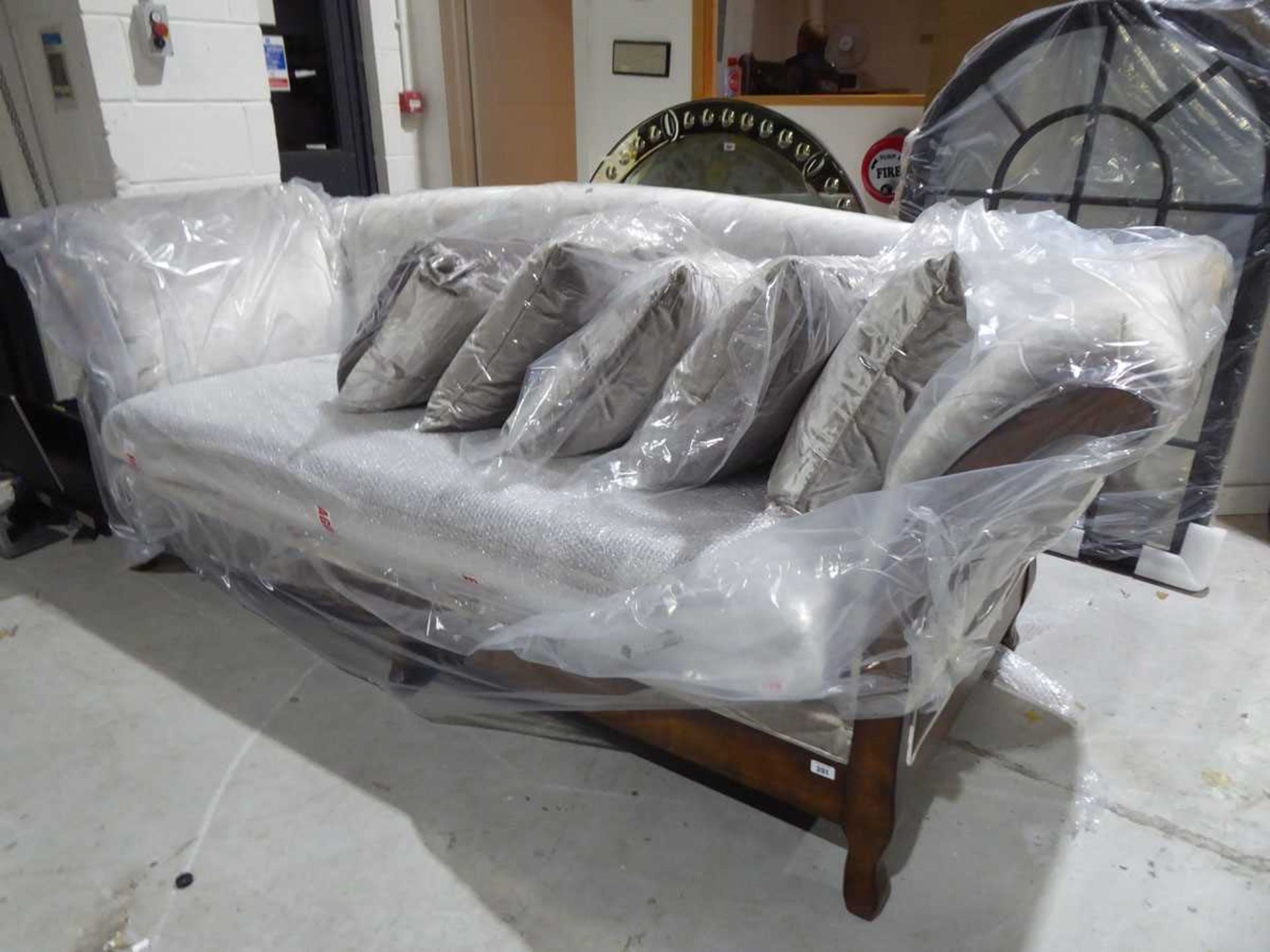 +VAT Large hardwood framed four seater sofa, upholstered in a silver finish with five loose