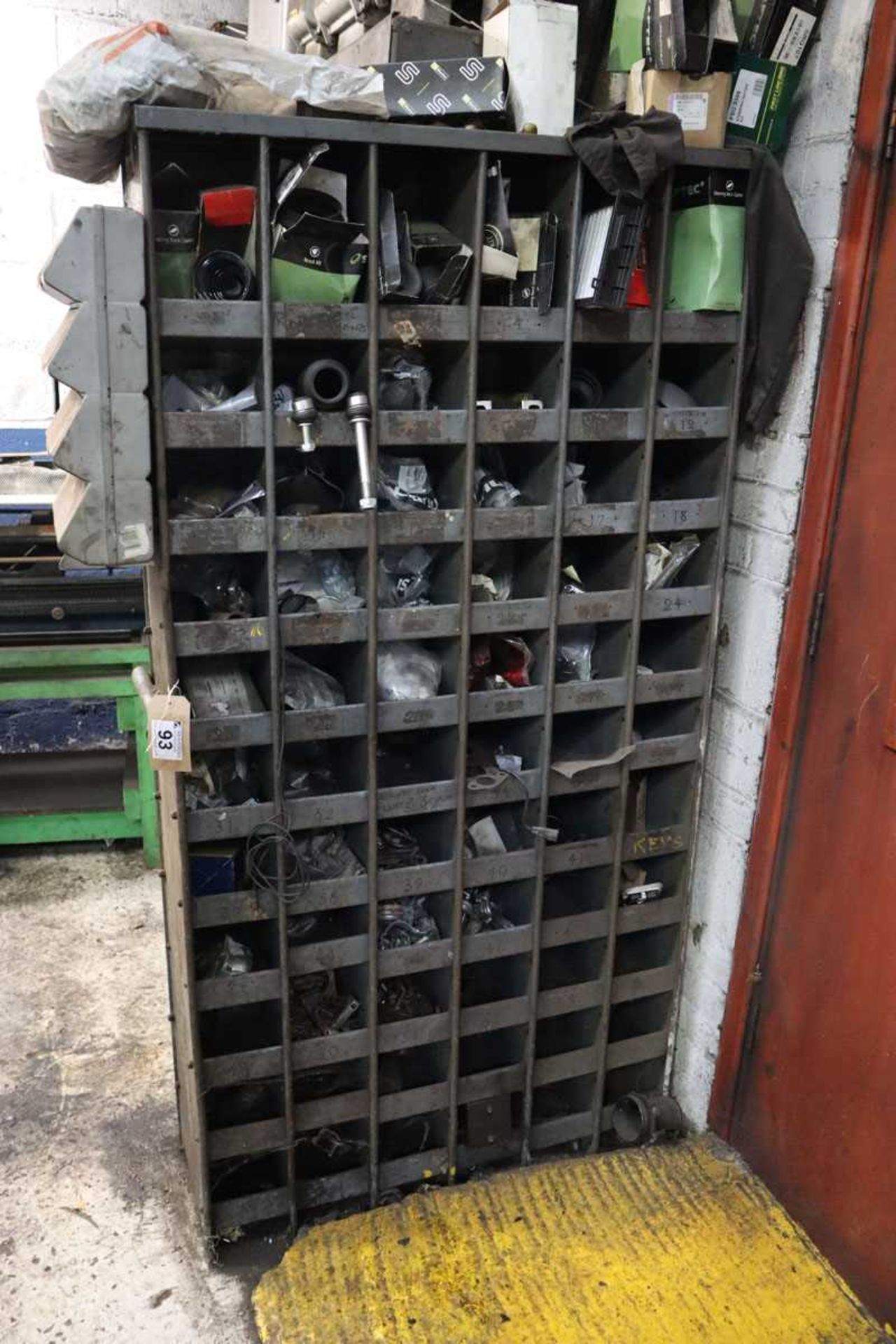 +VAT Mid 20th century pigeon hole rack containing a variety of vehicle spares and consumables