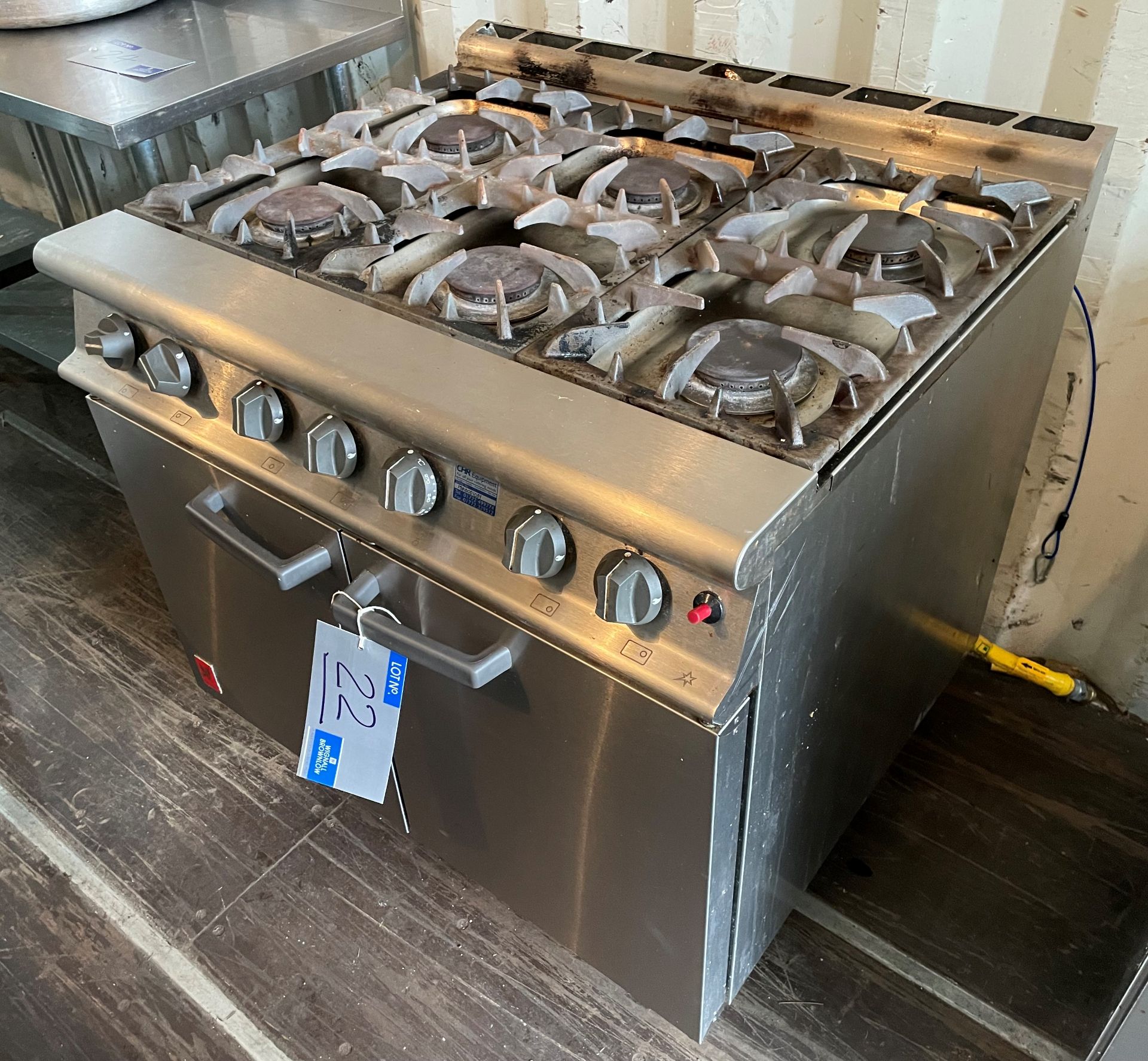 A Falcon G3101 6 ring Double Door Gas Range, one cast iron pan support cracked (located at EMS Asset
