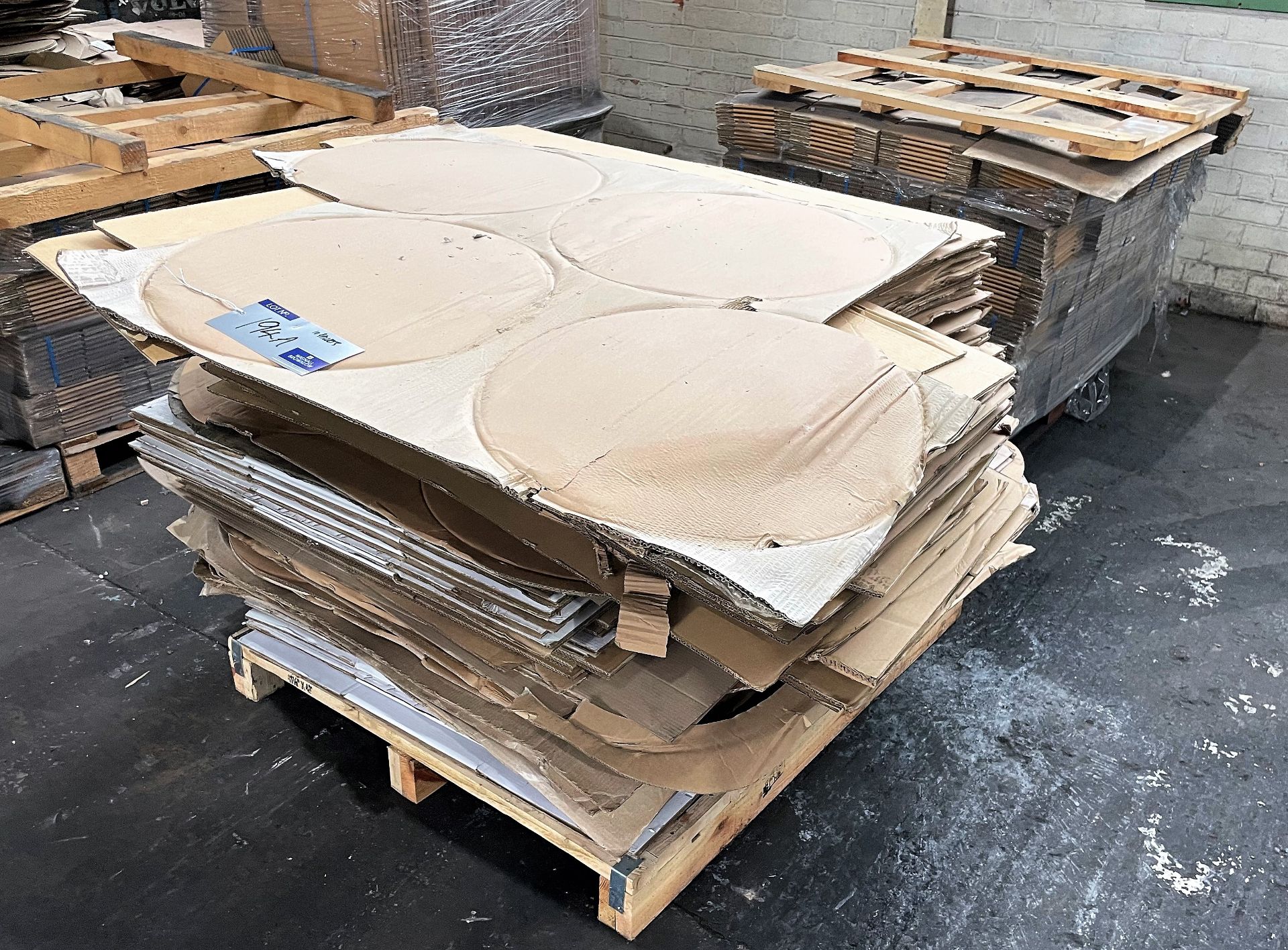A Large Quantity of Assorted Flat Cardboard Boxes and Wheel Hub Separators on 10 pallets.