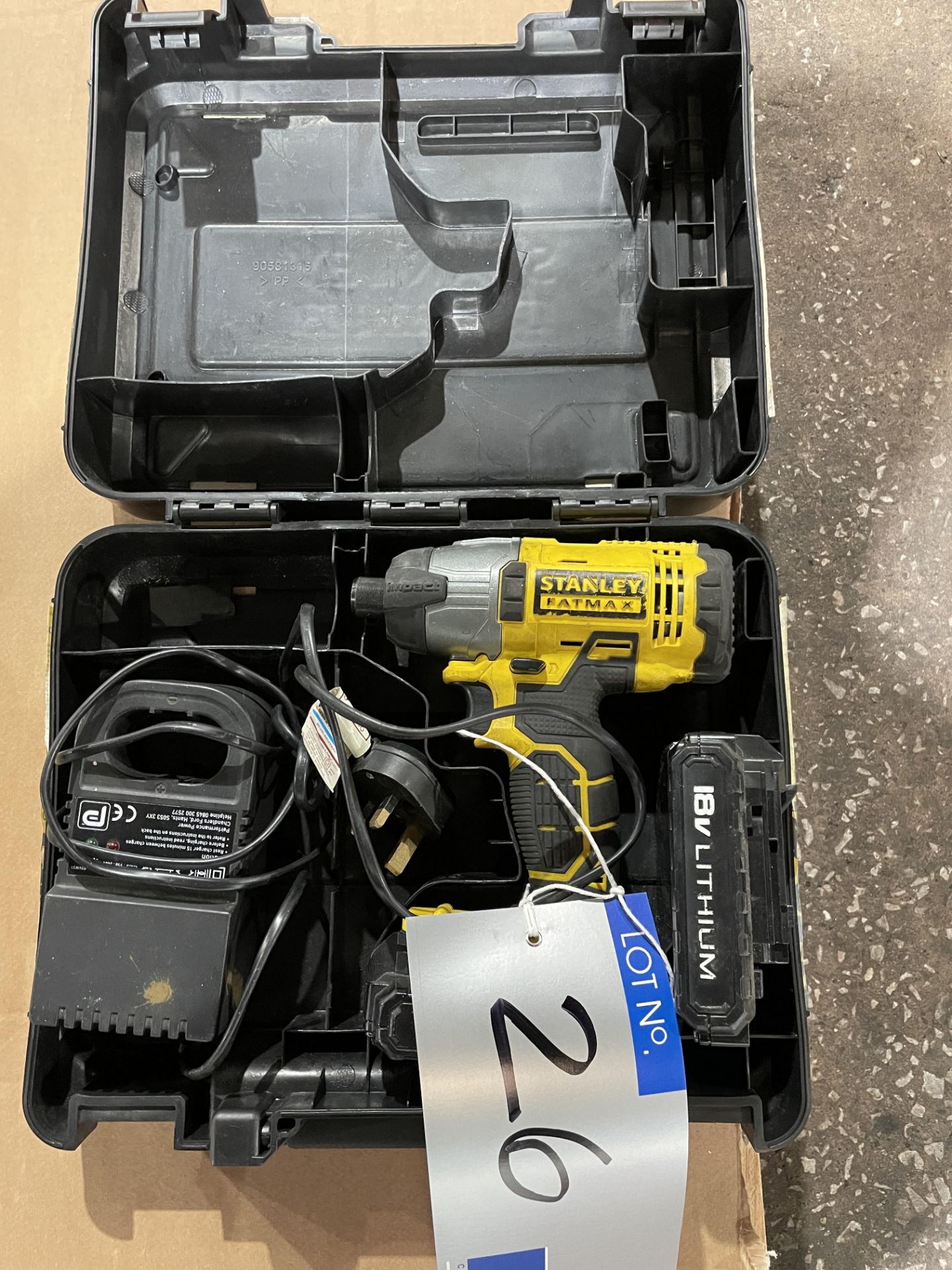 A Stanley FATMAX FMC641 Cordless Impact Driver with spare battery, charger and case.