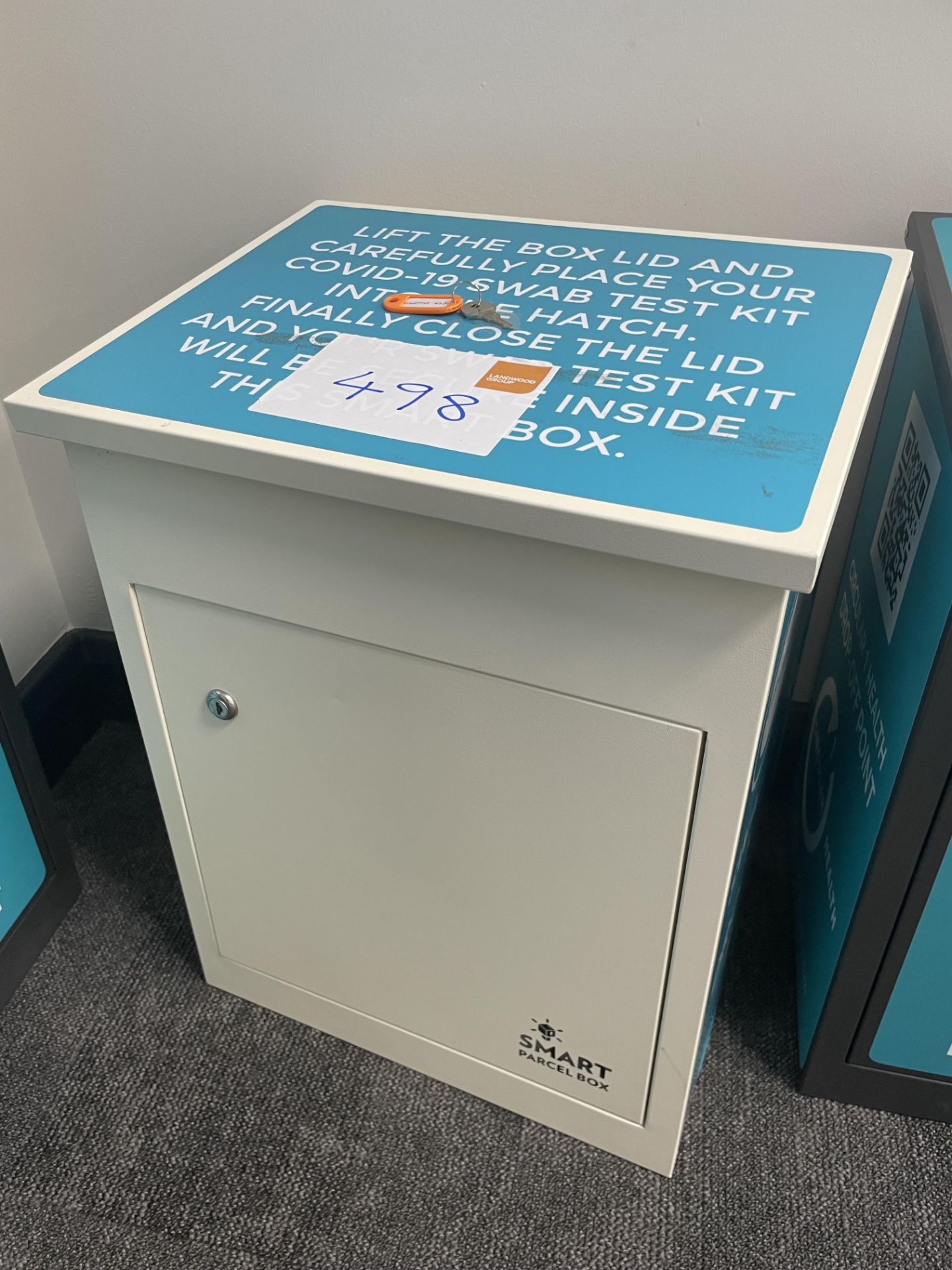 A Smart Parcel Box drop box with lifting lid and lock cabinet (key), white, 41cm x 33cm x 47cm h.