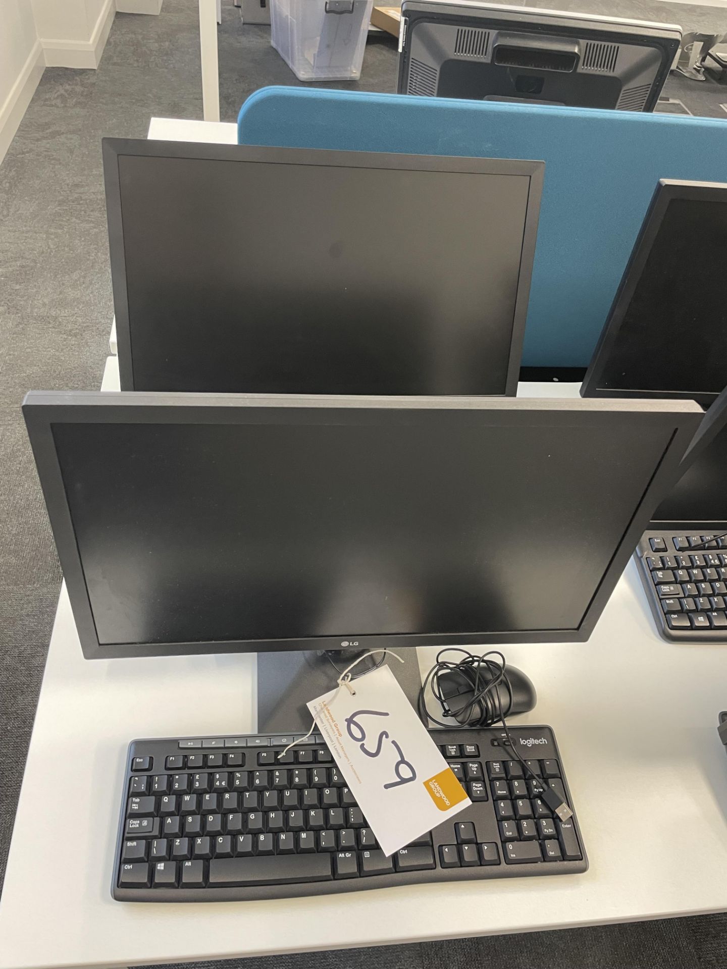 2 LG 22MK400H monitors (7/21) each with keyboard and mouse.