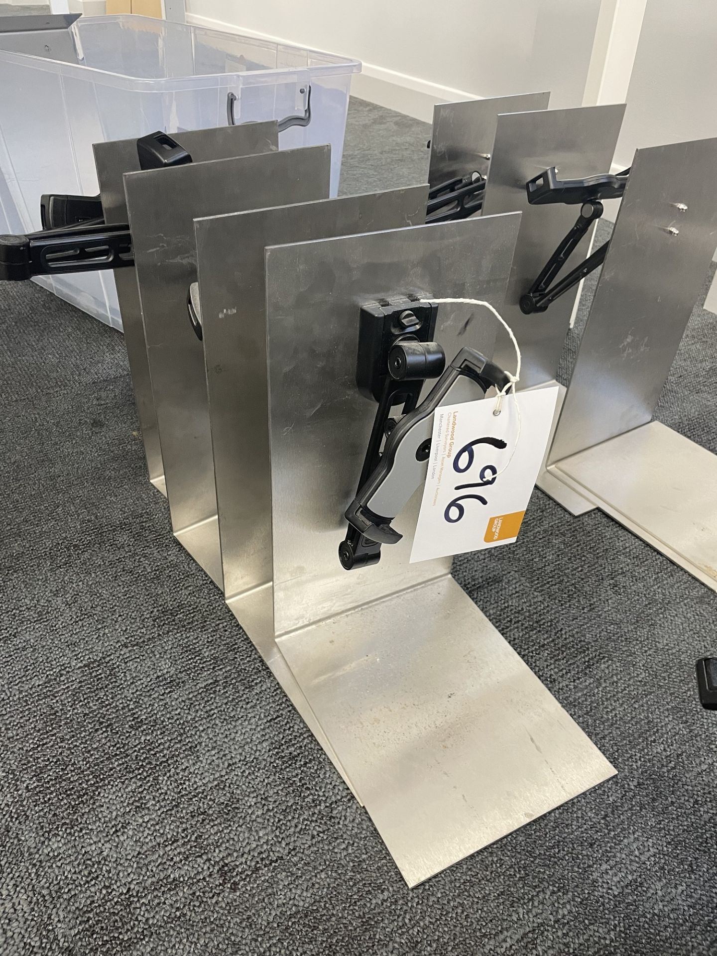 4 stainless steel tablet stands with tablet clamps.