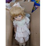 Vintage China doll in pink dress