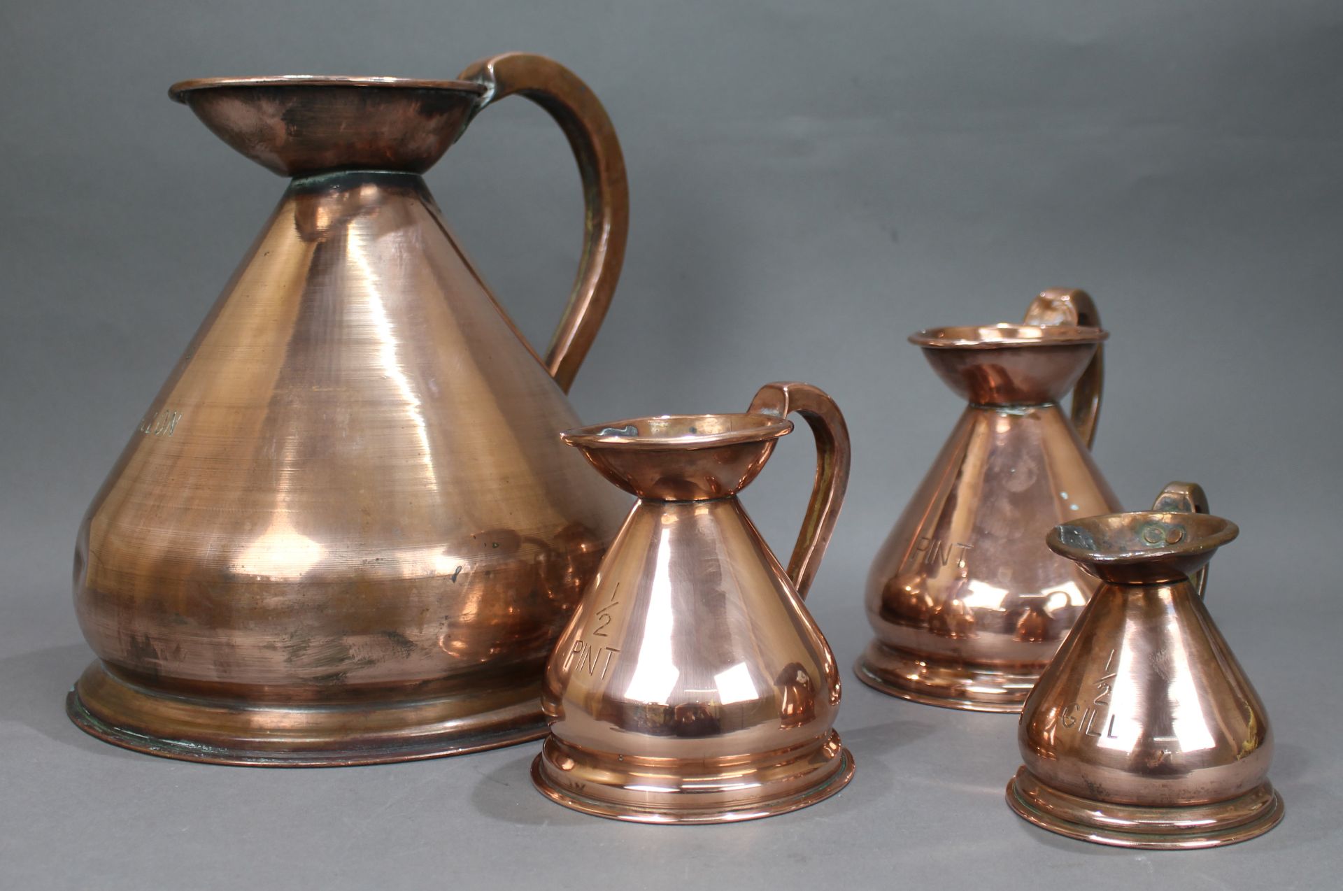 Set of 4 Antique Graduated Copper Jugs