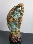 Russet and Celadon Jadeite / Jade Carved Buddha Boulder Sculpture On A Wooden Stand
