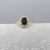 Oval-cut Sapphire and Round Brilliant-cut Diamond Cluster Ring In 18ct Yellow Gold