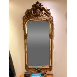 A LARGE ITALIAN GILTWOOD AND GESSO WALL MIRROR IN THE ROCOCCO MANNER, with large crests and oyster