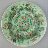 A CHINESE FAMILLE VERTE PLATE, mid 19th century decorated with peacocks and floral imagery. 34cm