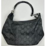 A GUCCI BLACK MONOGRAM HANDBAG WITH FAUX BAMBOO HANDLE, inner zipped compartments, 35cm x 20cm x