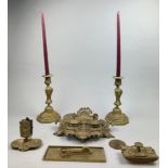A BRASS WRITING SET AND MEDALS, to include an ornate Rococo inkwell, two candlesticks, a letter