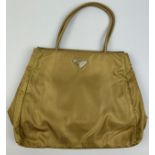 A PRADA KHAKI NYLON BAG, with inner zipped compartment. 35cm x 24cm x 11cm