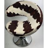 AN ANDREW MARTIN SWIVEL CHAIR UPHOLSTERED IN COW HIDE PRINT FABRIC.