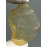 A NEOLITHIC SCRAPING TOOL IN DESERT GLASS TEKTITE, From the Tenerean Culture, tool was worked