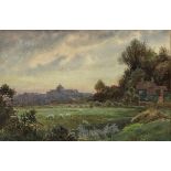 A WATERCOLOUR SCENE OF FIELDS LOOKING TOWARDS A VILLAGE, signed N.P Edwards, mounted in a frame