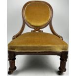 ATTRIBUTED TO CHARLES BEVAN FOR GILLOWS NURSING CHAIR, upholstered in green velvet.