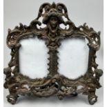 A VICTORIAN ROCCOCO STYLE CAST COPPER PICTURE FRAME, with cherubs and a central figure