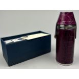 AN ASPINAL OF LONDON PURPLE LEATHER AND STEEL WHISKEY FLASK, in original box.