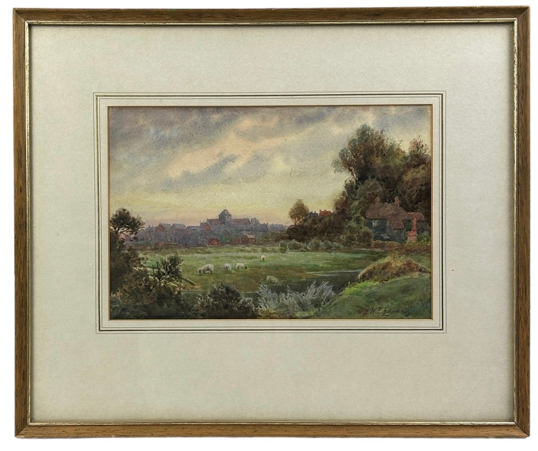 A WATERCOLOUR SCENE OF FIELDS LOOKING TOWARDS A VILLAGE, signed N.P Edwards, mounted in a frame - Image 2 of 2